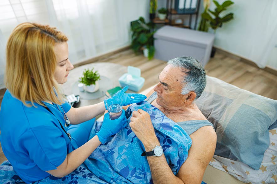 caregiver-assisting-elderly-man-in-home